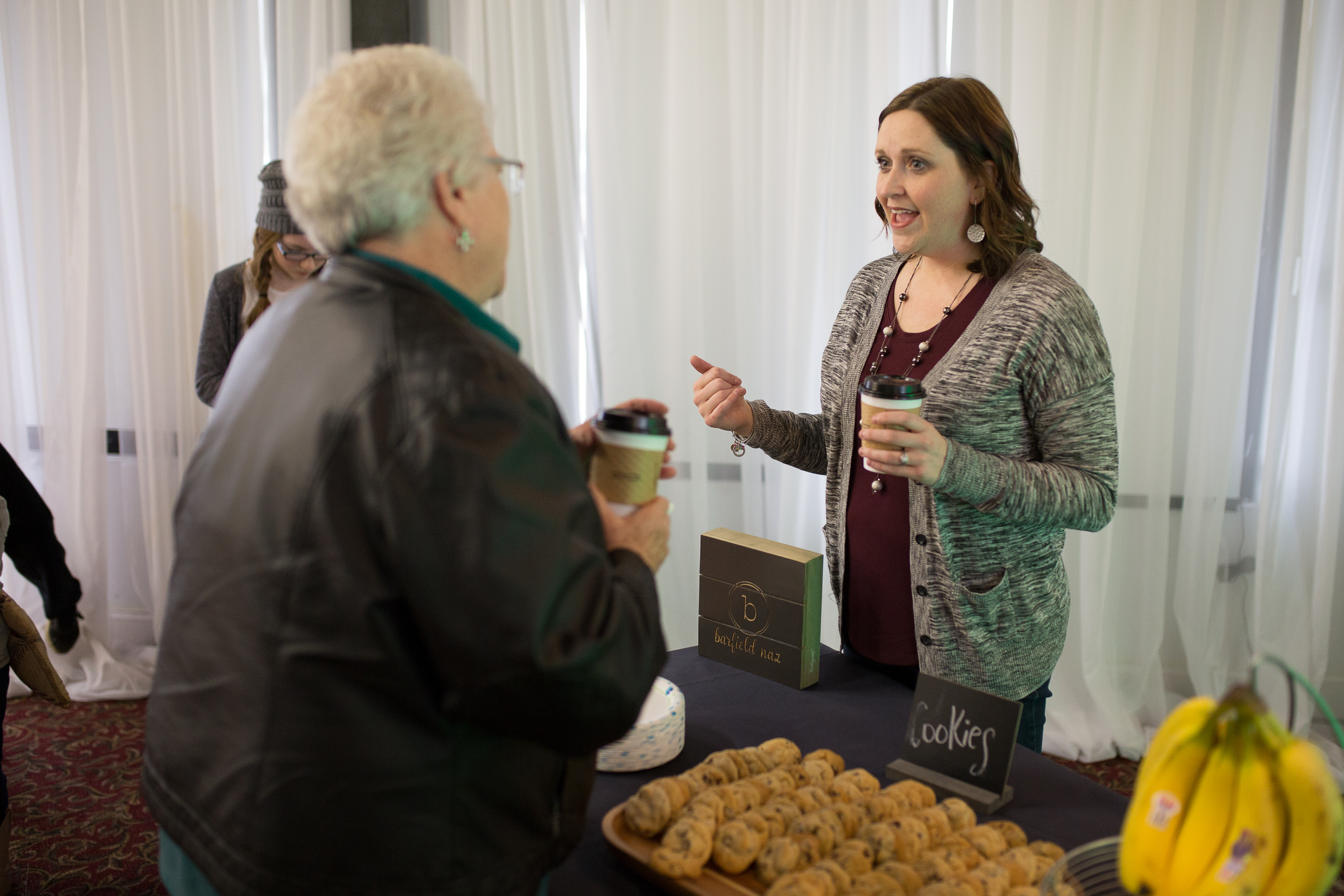 Image of people conversing over coffee and pastries