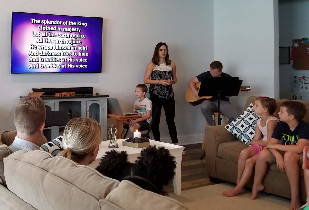 Image of several people playing instruments and singing